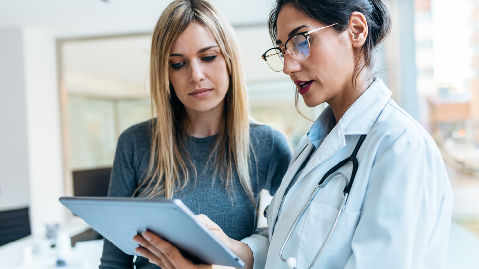 A clinician talks to a patient
